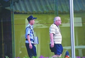 Via Sina, its caption: "A New Zealander is being taken away by police after tossing a young girl into a swimming pool in Jinan, Shandong province, Sunday."