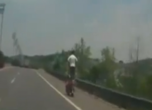 Standing on motorcycle on highway featured image