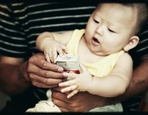 Help Us Caption This Cute Baby With A Pack Of Cigarettes