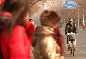 Huntsman rides a bike in Beijing