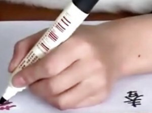 Chinese Woman Writes With Both Hands Concurrently In English And Chinese