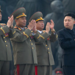 North Korean leader Kim Jong-Un (R) clap