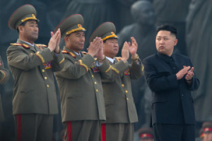 North Korean leader Kim Jong-Un (R) clap