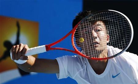 Wu Di of China hits a return to Ivan Dodig of Croatia during their men's single match at the Australian Open tennis tournament in Melbourne
