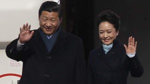 Chinese President Xi and First Lady Peng wave as they arrive at Moscow's Vnukovo airport