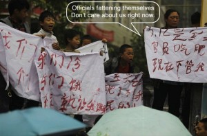 Sichuan earthquake victims hold banner saying officials don't care