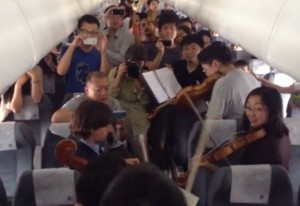 Philadelphia Orchestra in airplane aisle