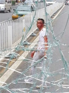 Man in Beijing leaps from overpass, shatters bus windshield