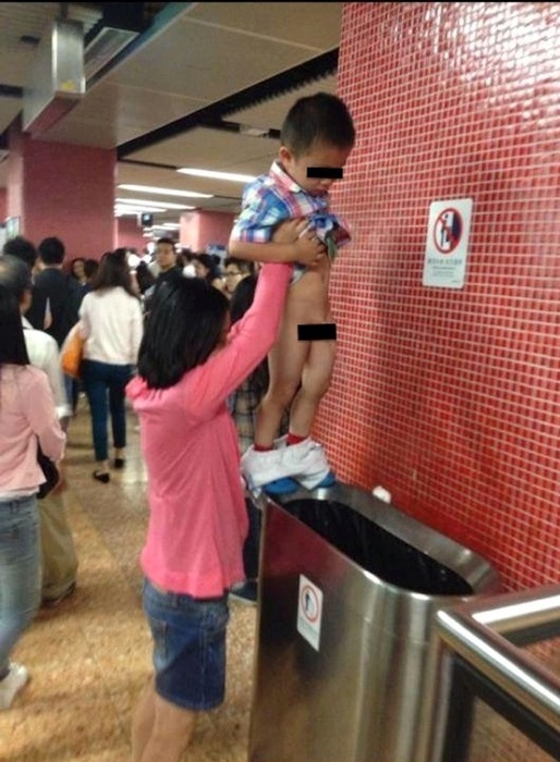 Boy pees into Hong Kong subway trash can