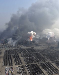An aerial picture of smoke rising at the site of the explosions is seen at the Binhai new district, Tianjin